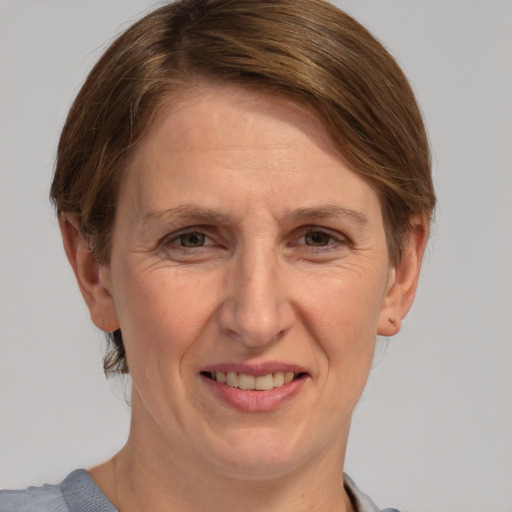 Joyful white adult female with short  brown hair and grey eyes