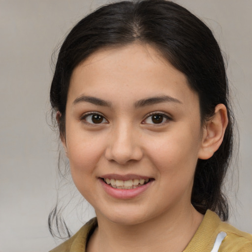 Joyful latino young-adult female with medium  brown hair and brown eyes