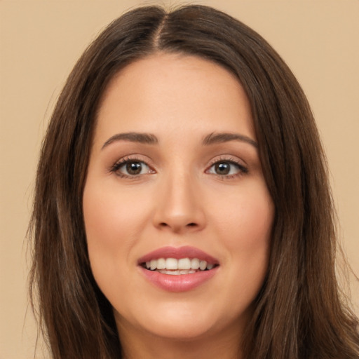 Joyful white young-adult female with long  brown hair and brown eyes