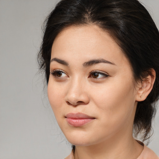 Joyful asian young-adult female with medium  brown hair and brown eyes