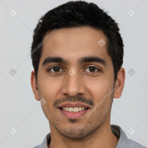 Joyful latino young-adult male with short  black hair and brown eyes