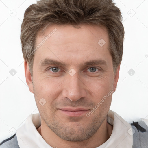 Joyful white adult male with short  brown hair and grey eyes