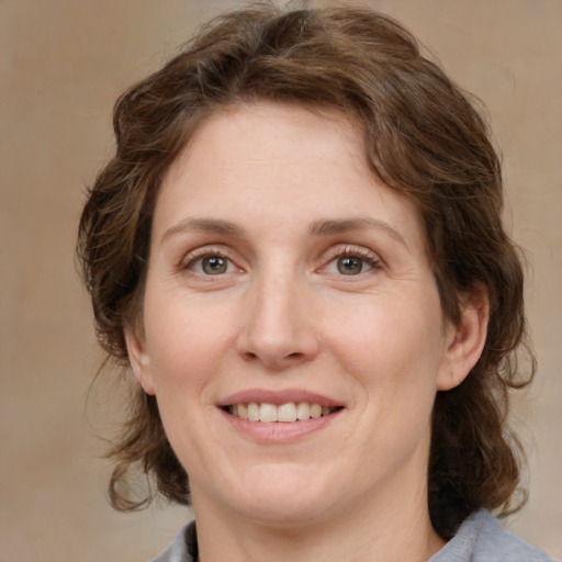 Joyful white young-adult female with medium  brown hair and green eyes