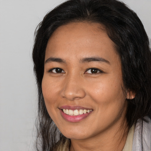 Joyful asian young-adult female with long  black hair and brown eyes