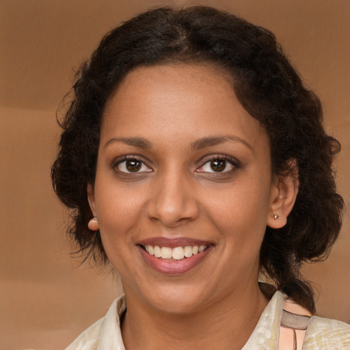 Joyful black young-adult female with medium  brown hair and brown eyes