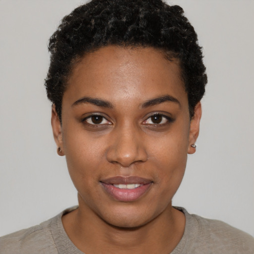Joyful black young-adult female with short  black hair and brown eyes