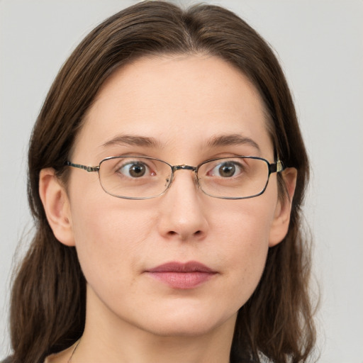 Joyful white young-adult female with long  brown hair and grey eyes