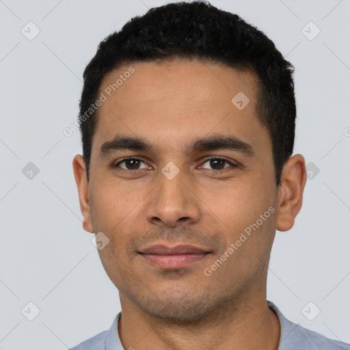 Joyful latino young-adult male with short  black hair and brown eyes