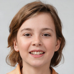 Joyful white child female with medium  brown hair and brown eyes