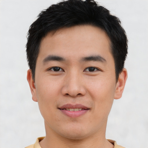 Joyful asian young-adult male with short  brown hair and brown eyes