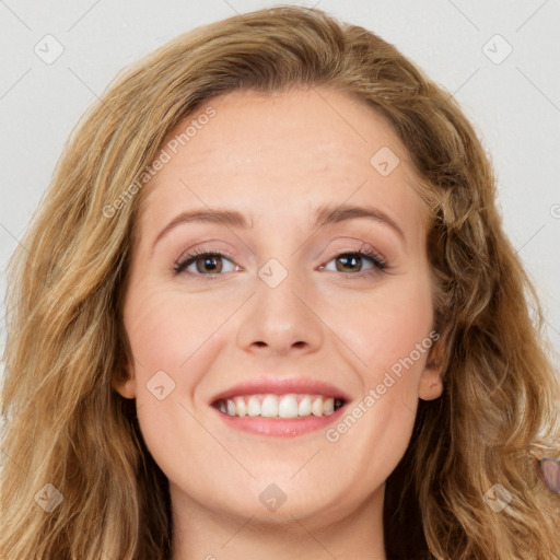 Joyful white young-adult female with long  brown hair and blue eyes