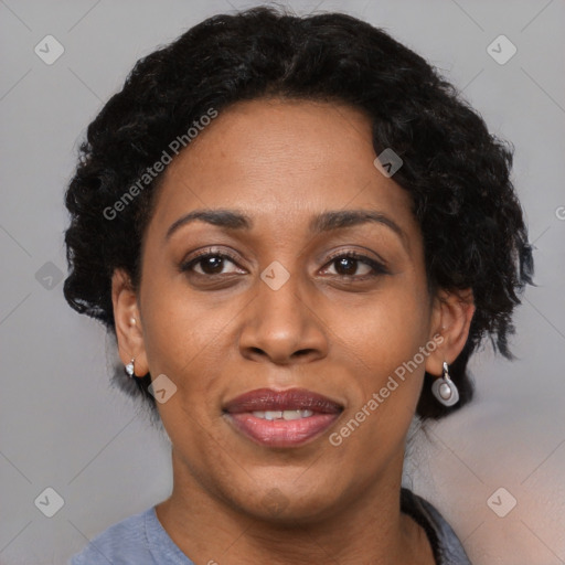 Joyful black adult female with short  brown hair and brown eyes