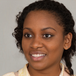 Joyful black young-adult female with medium  brown hair and brown eyes