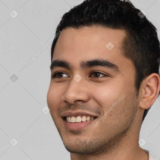 Joyful white young-adult male with short  black hair and brown eyes