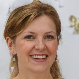 Joyful white adult female with medium  brown hair and grey eyes