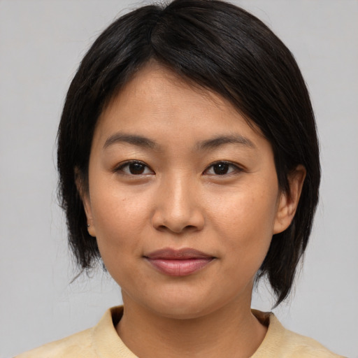 Joyful asian young-adult female with medium  brown hair and brown eyes