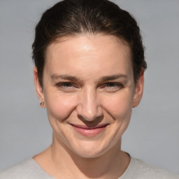 Joyful white adult female with short  brown hair and brown eyes