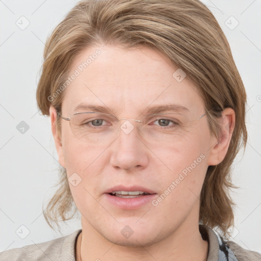 Joyful white adult female with medium  brown hair and blue eyes