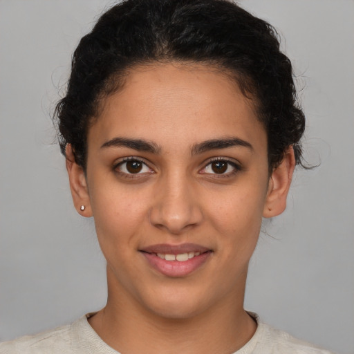 Joyful latino young-adult female with short  brown hair and brown eyes