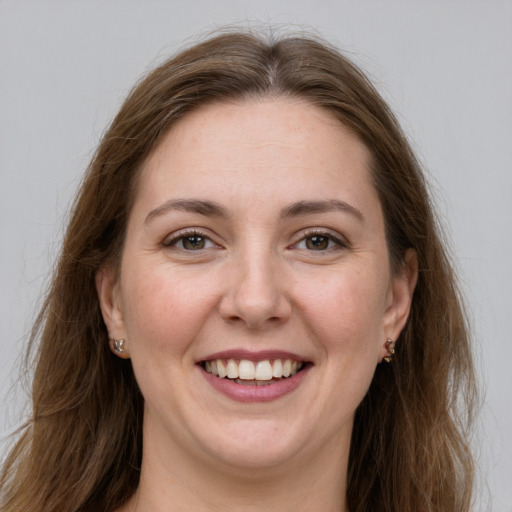 Joyful white young-adult female with long  brown hair and grey eyes