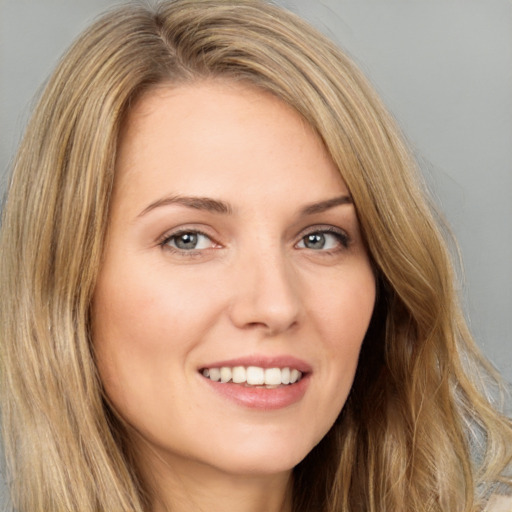 Joyful white young-adult female with long  brown hair and brown eyes