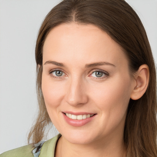 Joyful white young-adult female with long  brown hair and grey eyes