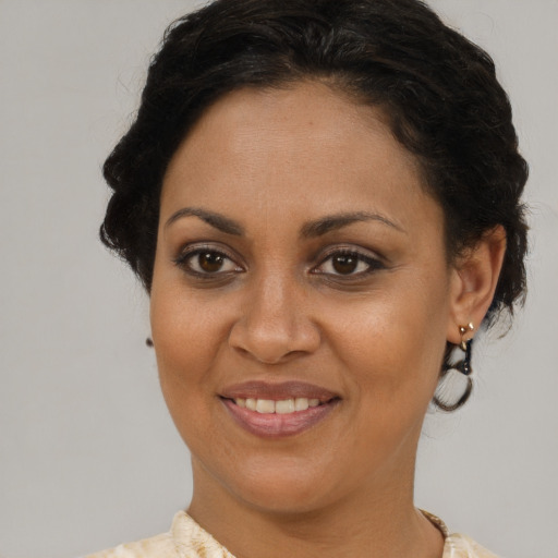 Joyful black adult female with short  brown hair and brown eyes