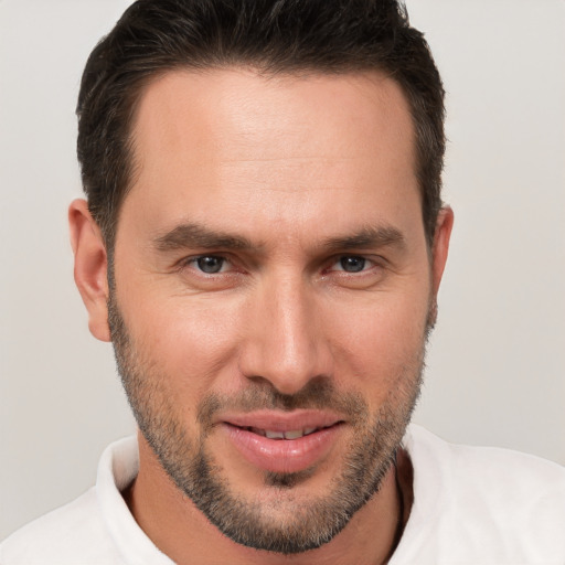 Joyful white young-adult male with short  brown hair and brown eyes