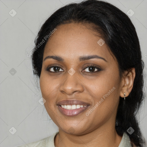 Joyful black young-adult female with long  black hair and brown eyes