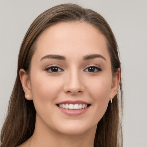 Joyful white young-adult female with long  brown hair and grey eyes