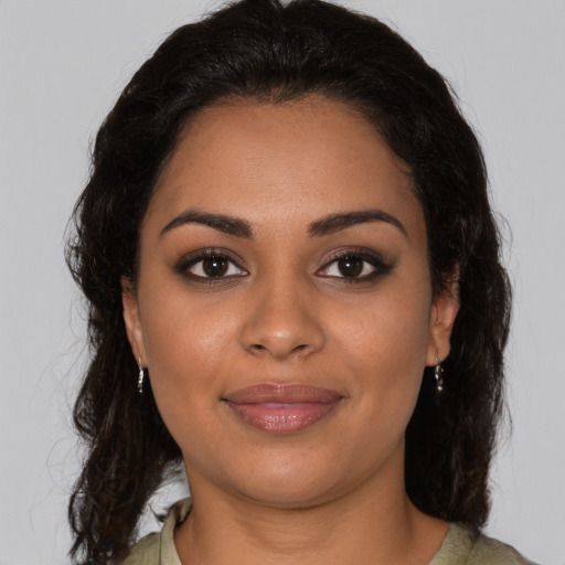 Joyful latino young-adult female with medium  brown hair and brown eyes