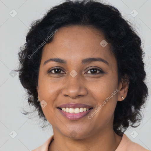 Joyful black young-adult female with long  brown hair and brown eyes