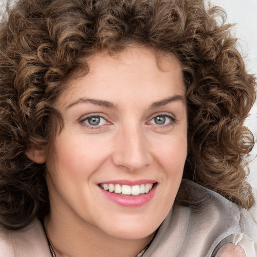 Joyful white young-adult female with medium  brown hair and green eyes