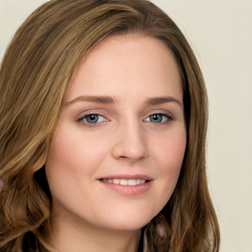 Joyful white young-adult female with long  brown hair and green eyes