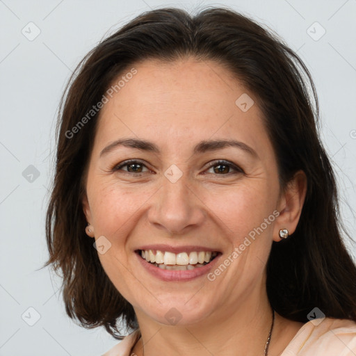 Joyful white adult female with medium  brown hair and brown eyes