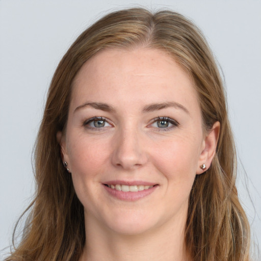 Joyful white young-adult female with long  brown hair and blue eyes