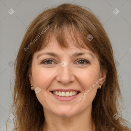 Joyful white adult female with long  brown hair and brown eyes