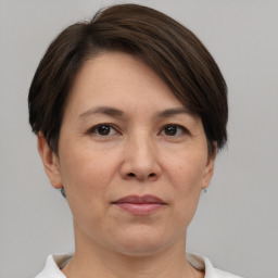 Joyful white adult female with short  brown hair and brown eyes