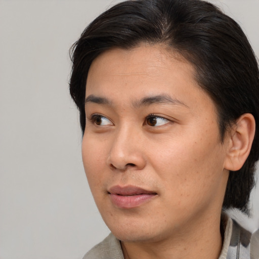 Joyful asian young-adult female with medium  brown hair and brown eyes
