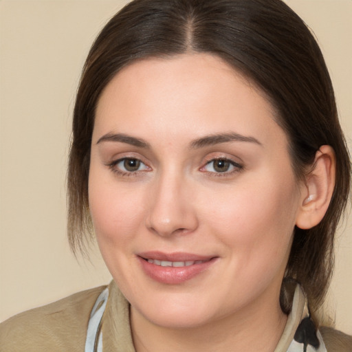 Joyful white young-adult female with medium  brown hair and brown eyes