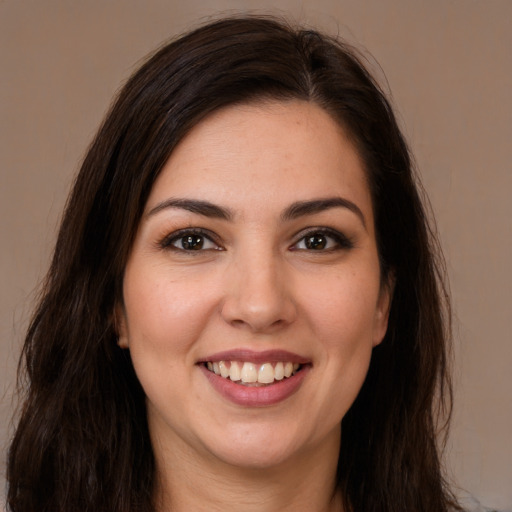 Joyful white young-adult female with long  brown hair and brown eyes