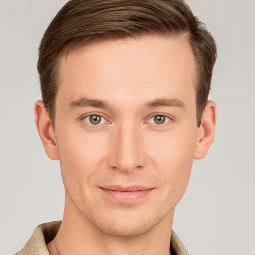 Joyful white young-adult male with short  brown hair and grey eyes