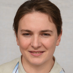 Joyful white young-adult female with medium  brown hair and grey eyes