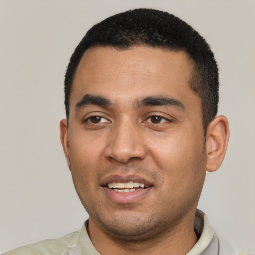 Joyful latino young-adult male with short  black hair and brown eyes