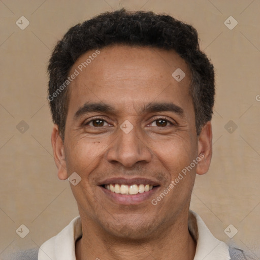 Joyful latino adult male with short  black hair and brown eyes