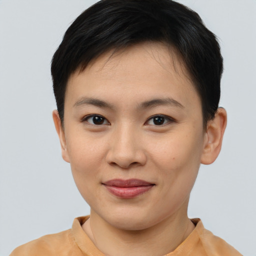 Joyful asian young-adult female with short  brown hair and brown eyes