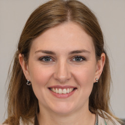 Joyful white young-adult female with medium  brown hair and grey eyes