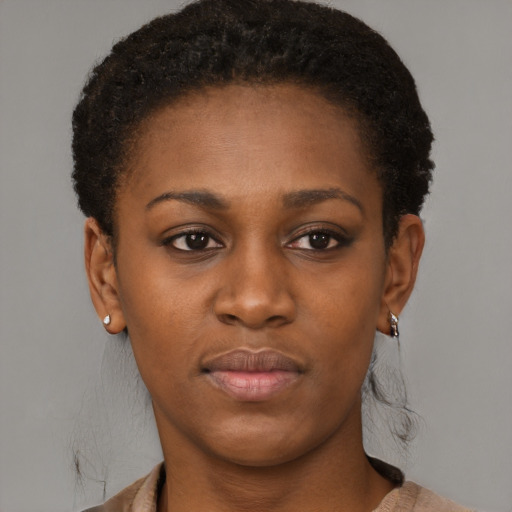 Joyful black young-adult female with short  black hair and brown eyes