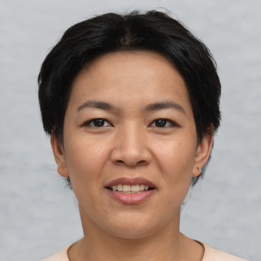 Joyful asian young-adult female with short  black hair and brown eyes