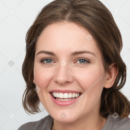 Joyful white young-adult female with medium  brown hair and blue eyes